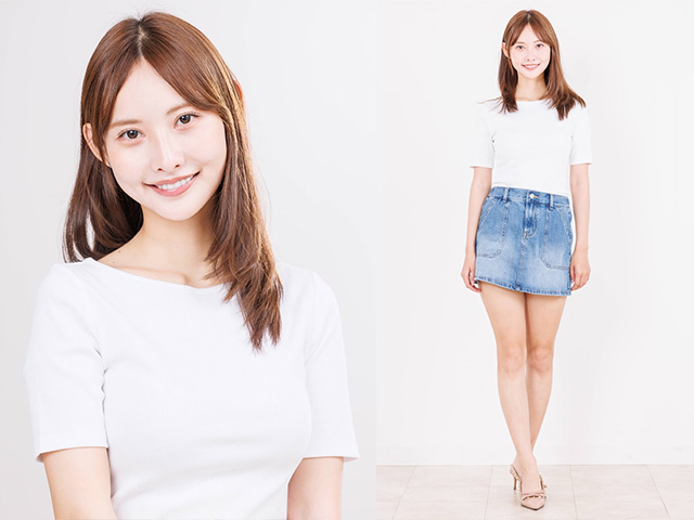Smiling woman wearing a white short-sleeve top and blue denim skirt standing against a white background.